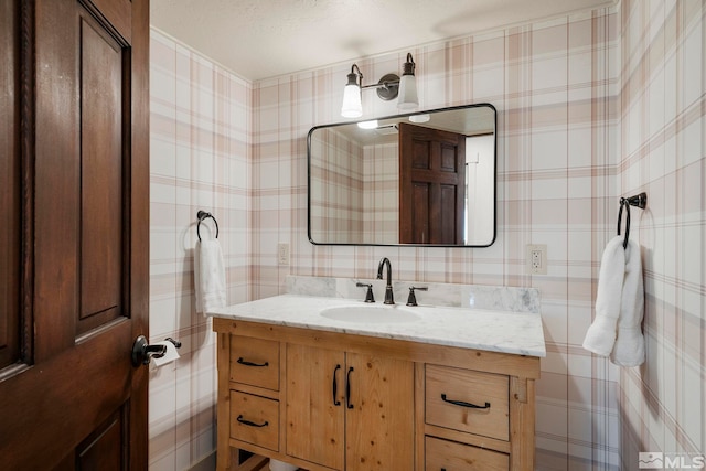 bathroom featuring vanity and a textured ceiling