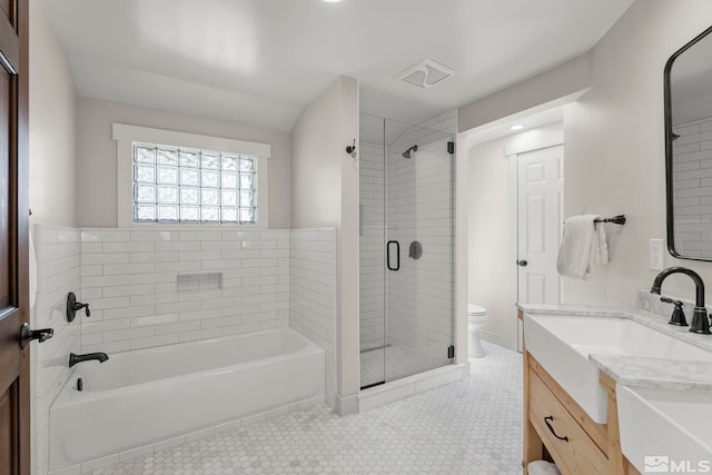 bathroom featuring vanity, toilet, and a shower with shower door