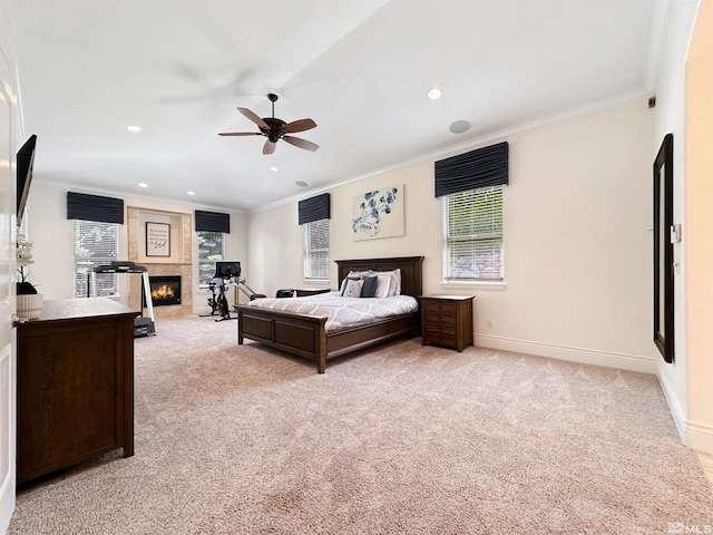 carpeted bedroom featuring ceiling fan, multiple windows, and crown molding