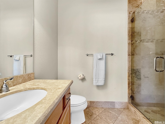 bathroom featuring vanity, toilet, walk in shower, and tile patterned flooring