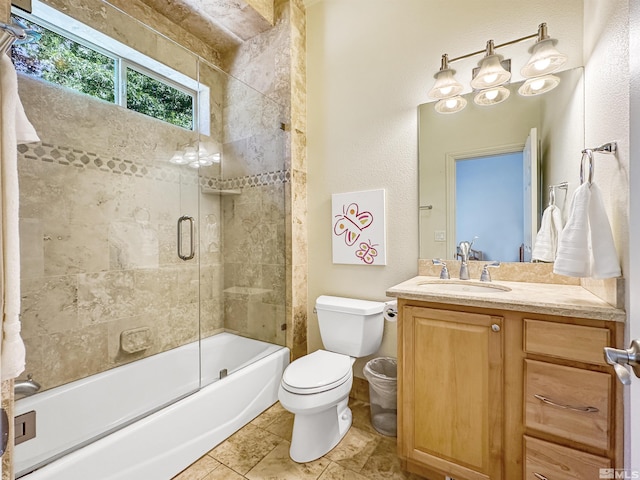 full bathroom featuring tile patterned floors, enclosed tub / shower combo, vanity, and toilet