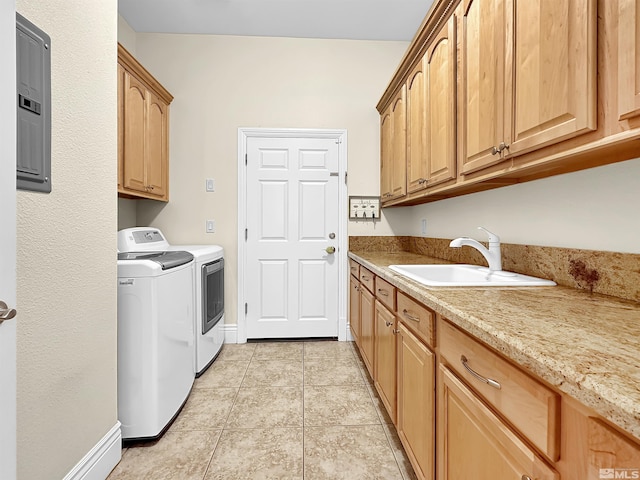 laundry room featuring washing machine and clothes dryer, light tile patterned floors, sink, electric panel, and cabinets