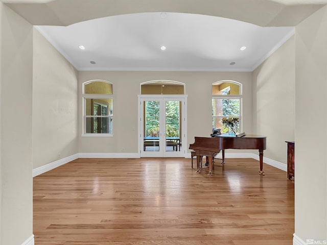 interior space with light wood-type flooring and ornamental molding