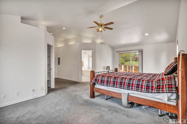 carpeted bedroom with ensuite bathroom, ceiling fan, and vaulted ceiling