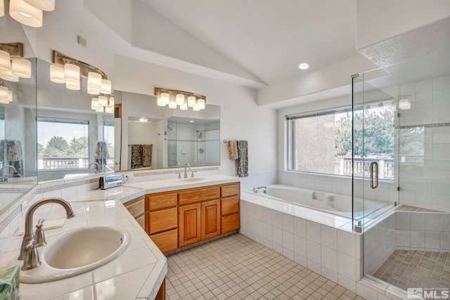 bathroom featuring shower with separate bathtub, vanity, tile patterned floors, and lofted ceiling