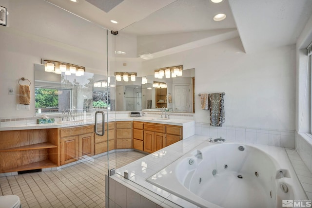 bathroom with vanity, tile patterned floors, lofted ceiling, and separate shower and tub