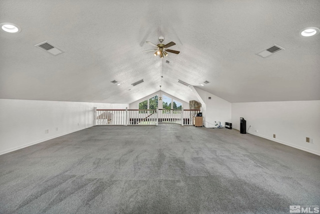 bonus room with vaulted ceiling, ceiling fan, and a textured ceiling