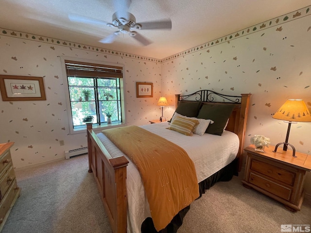 carpeted bedroom with a textured ceiling, ceiling fan, and baseboard heating