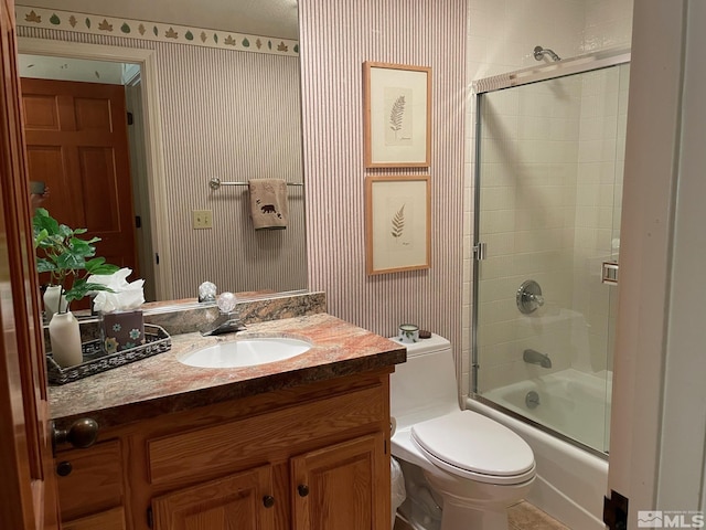 full bathroom with vanity, toilet, and combined bath / shower with glass door