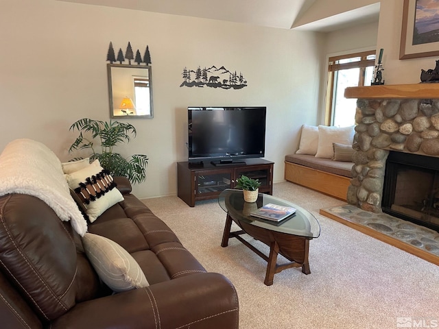 living room with a stone fireplace and carpet flooring