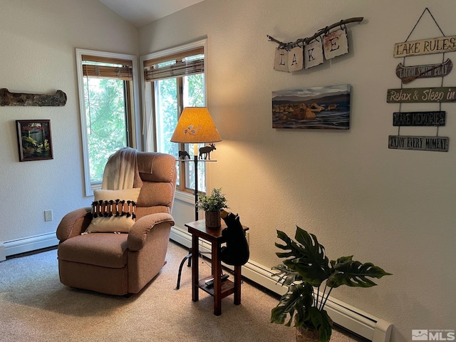 sitting room with carpet floors, vaulted ceiling, and a baseboard heating unit