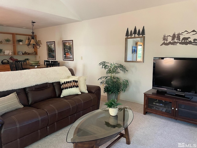 living room featuring lofted ceiling and carpet flooring