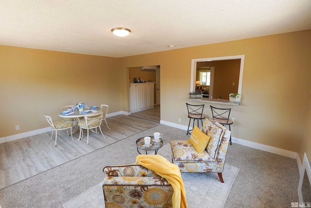 carpeted living room featuring a textured ceiling