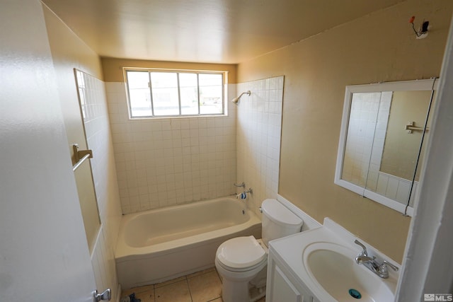 full bathroom with tile patterned flooring, vanity, tiled shower / bath combo, and toilet