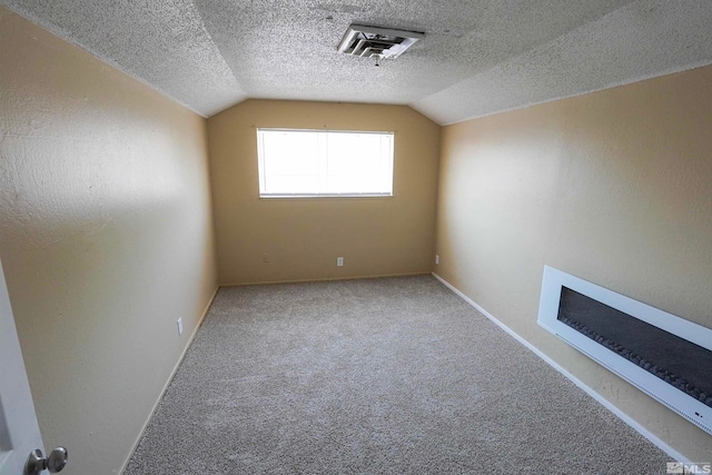 bonus room with a textured ceiling, carpet floors, and lofted ceiling