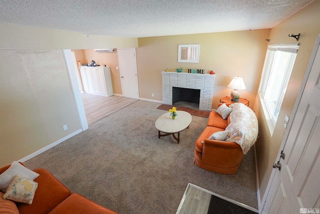 living room featuring carpet flooring, a textured ceiling, and a brick fireplace