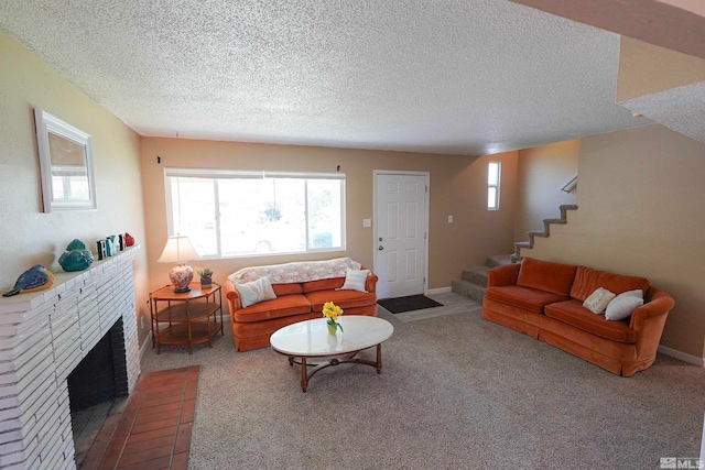 living room featuring carpet, a fireplace, and a textured ceiling