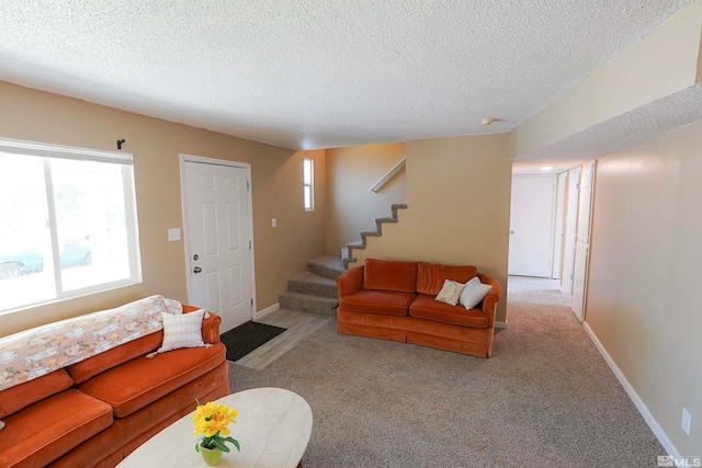 carpeted living room with a textured ceiling and a healthy amount of sunlight