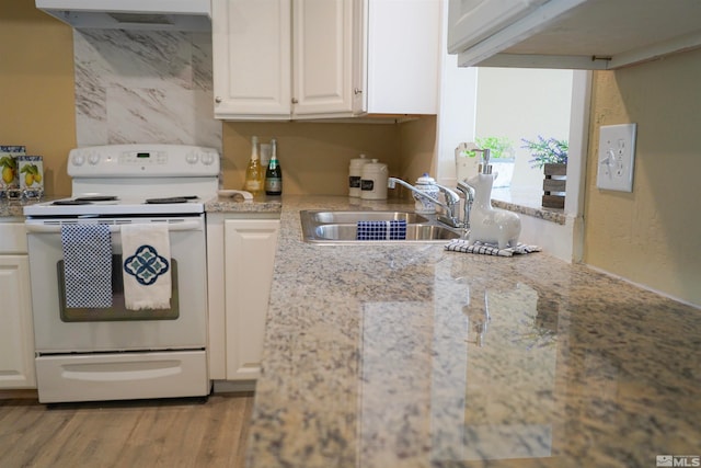 kitchen with white cabinetry, sink, light stone countertops, white range with electric stovetop, and light wood-type flooring