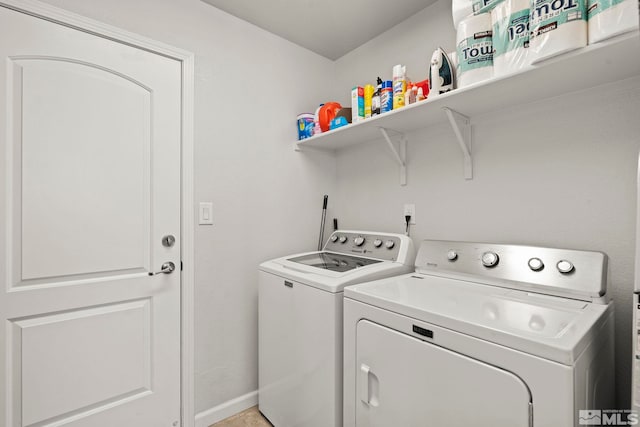 clothes washing area with washing machine and clothes dryer