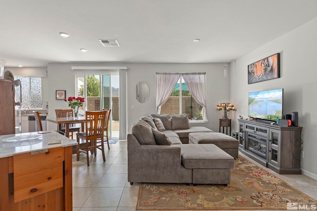 living room with a healthy amount of sunlight and light tile patterned flooring