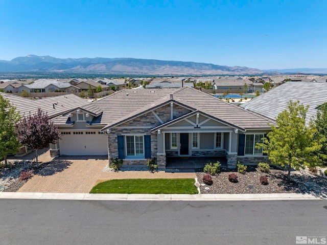 view of front of property with a mountain view and a garage