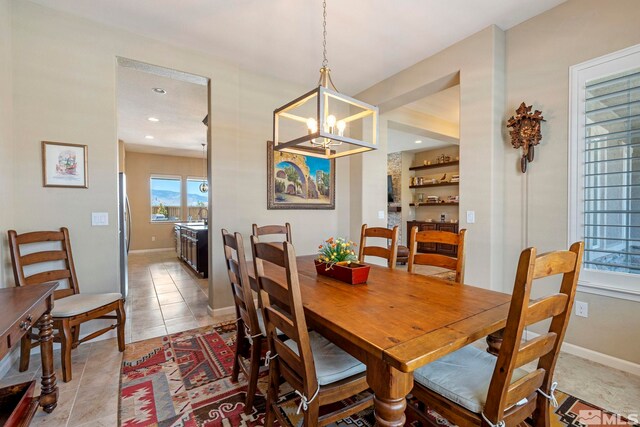 tiled dining space with an inviting chandelier and sink