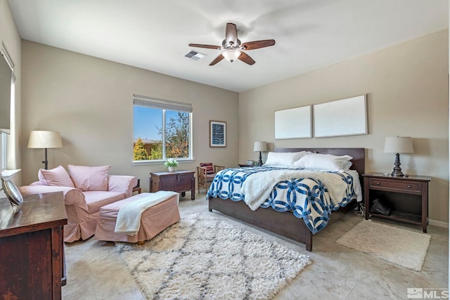 bedroom with ceiling fan and tile patterned flooring