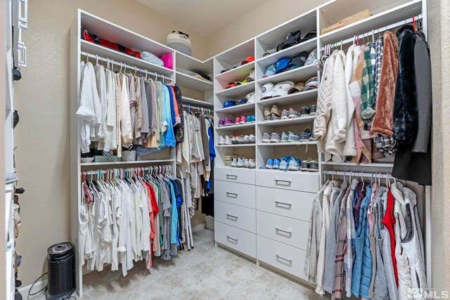 spacious closet featuring light tile patterned flooring