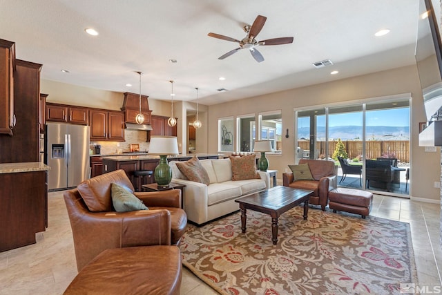 tiled living room with ceiling fan