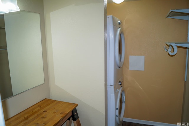 clothes washing area featuring stacked washer and clothes dryer