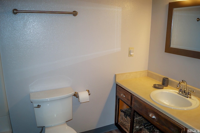 bathroom with toilet and vanity