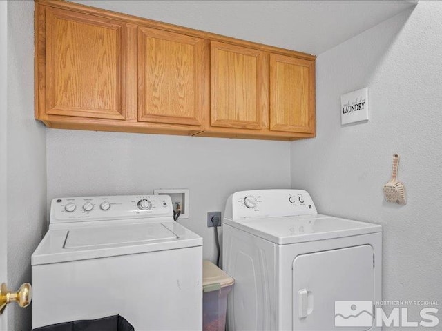 clothes washing area with cabinet space and washing machine and dryer