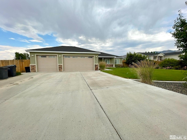 ranch-style home with a garage and a front yard