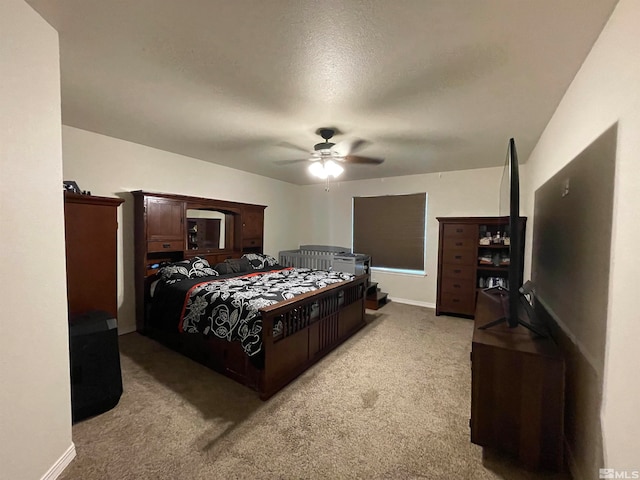 bedroom featuring a textured ceiling, ceiling fan, and carpet flooring