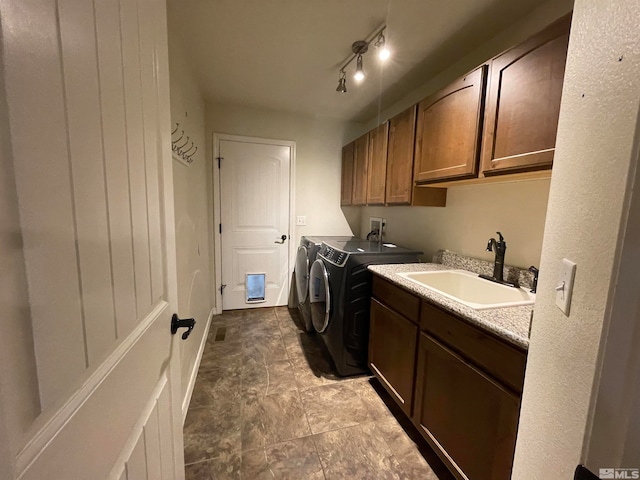 laundry room featuring tile patterned floors, sink, cabinets, independent washer and dryer, and track lighting