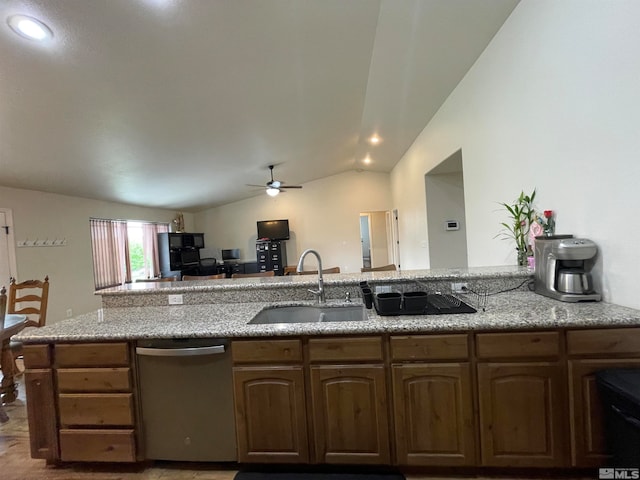 kitchen with sink, light stone counters, stainless steel dishwasher, lofted ceiling, and ceiling fan