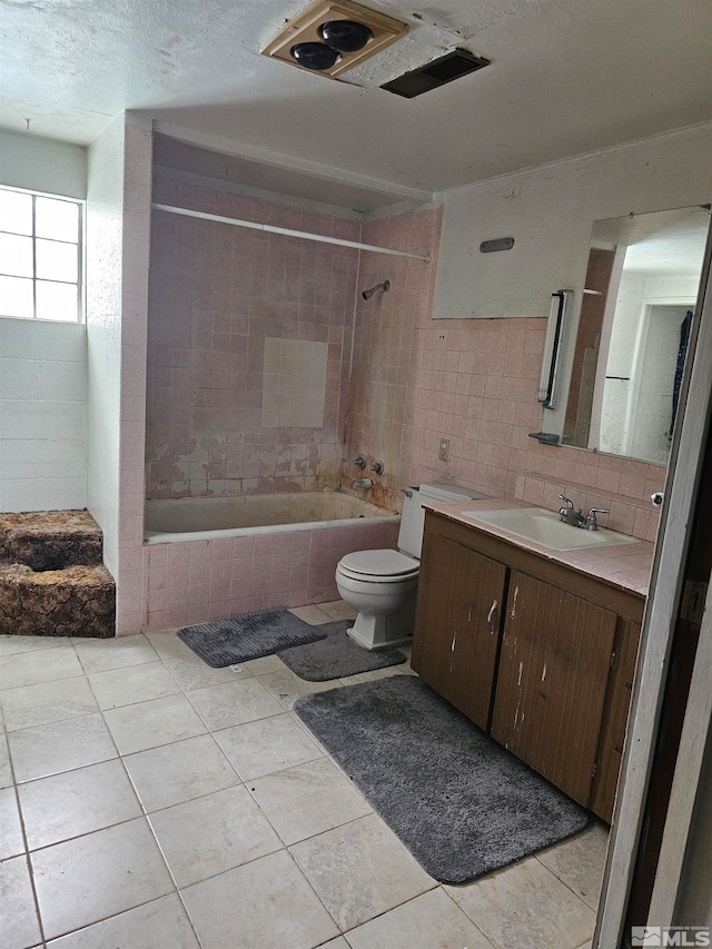 full bathroom featuring vanity, tiled shower / bath combo, toilet, tile patterned flooring, and backsplash