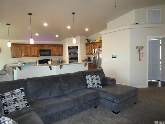 carpeted living room featuring vaulted ceiling