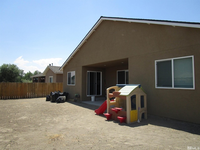 rear view of house with a playground