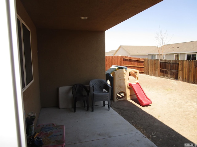 view of patio featuring a playground