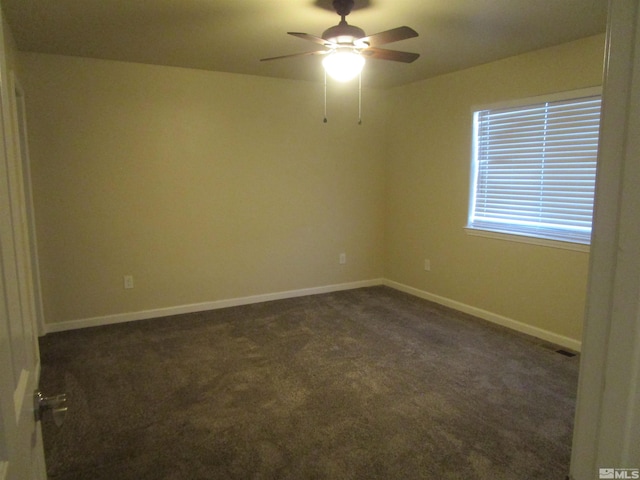 unfurnished room featuring ceiling fan and dark colored carpet