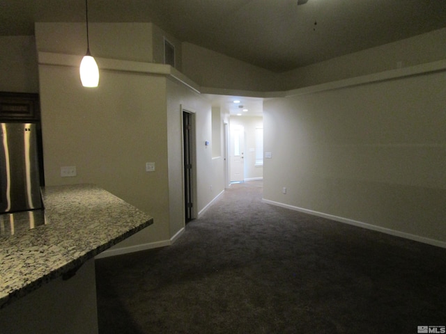 hall featuring vaulted ceiling and dark carpet