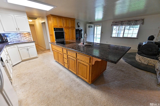 kitchen with light carpet, white cabinetry, and tasteful backsplash