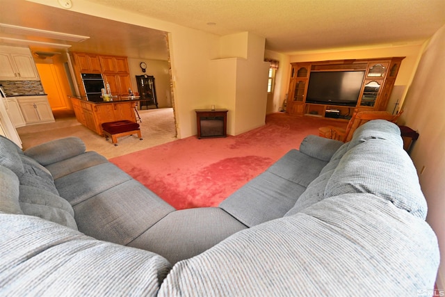 carpeted living room featuring a textured ceiling