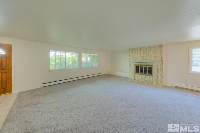 unfurnished living room with light colored carpet, baseboard heating, and a fireplace