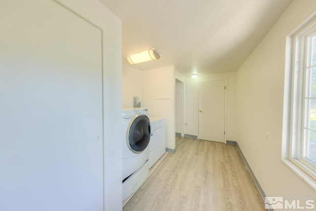 laundry area with light wood-type flooring, plenty of natural light, and independent washer and dryer