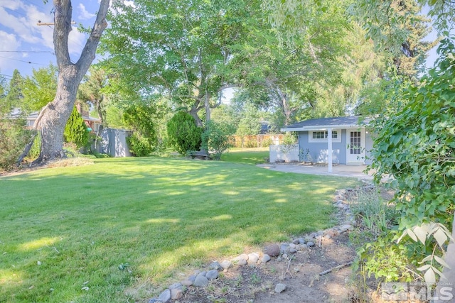 view of yard with an outdoor structure and a patio