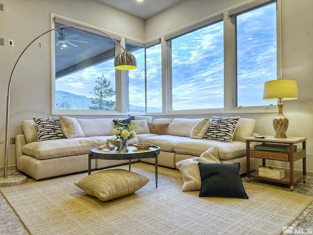 sunroom / solarium featuring ceiling fan