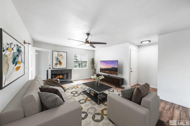 living room featuring wood-type flooring and ceiling fan